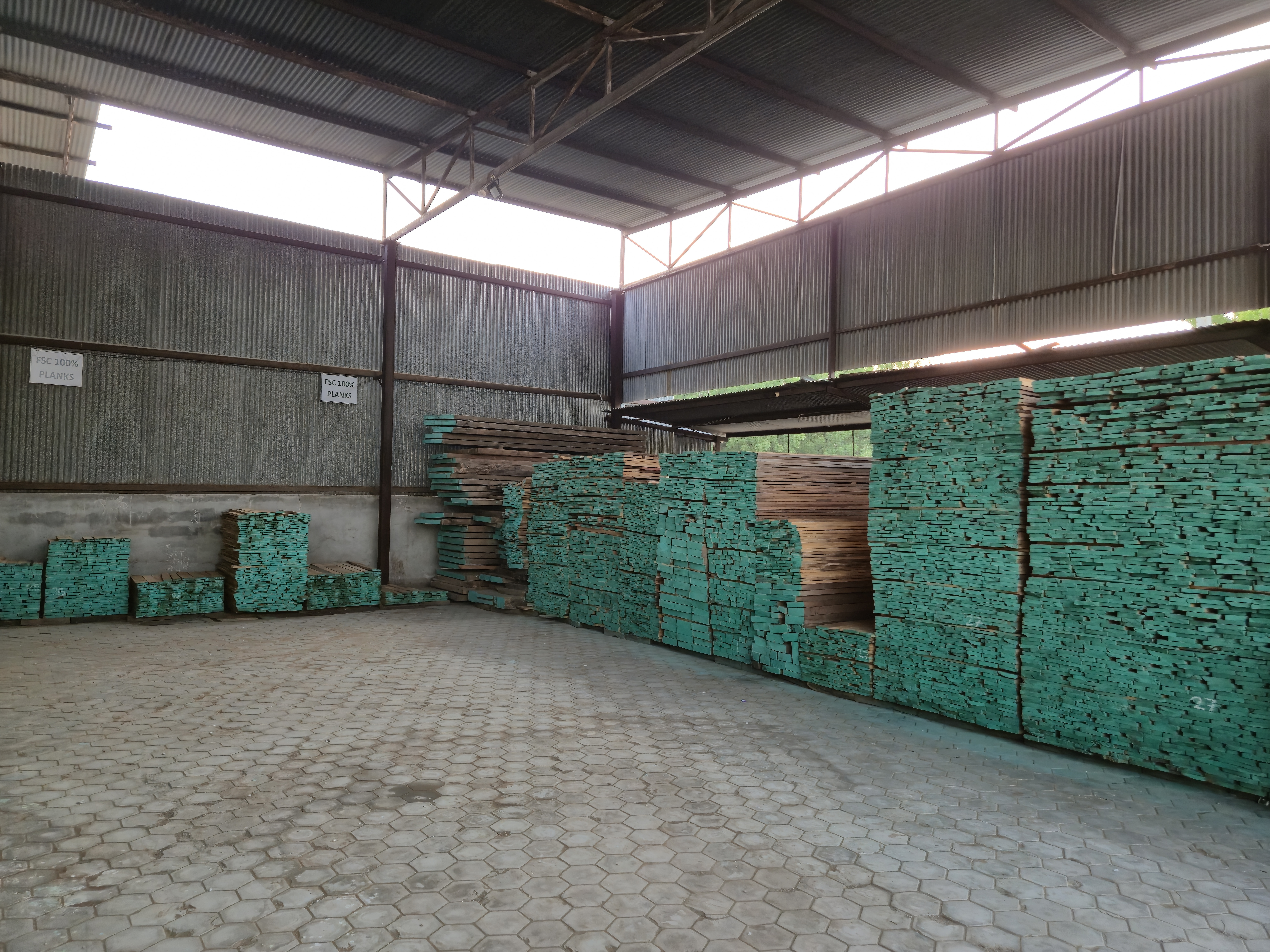Horizon Wood Timber warehouse with stacked teak wood logs
